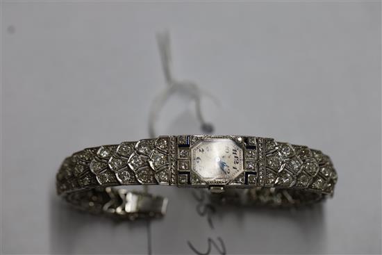 A ladys mid 20th century 18ct white gold, sapphire and diamond set manual wind cocktail watch,